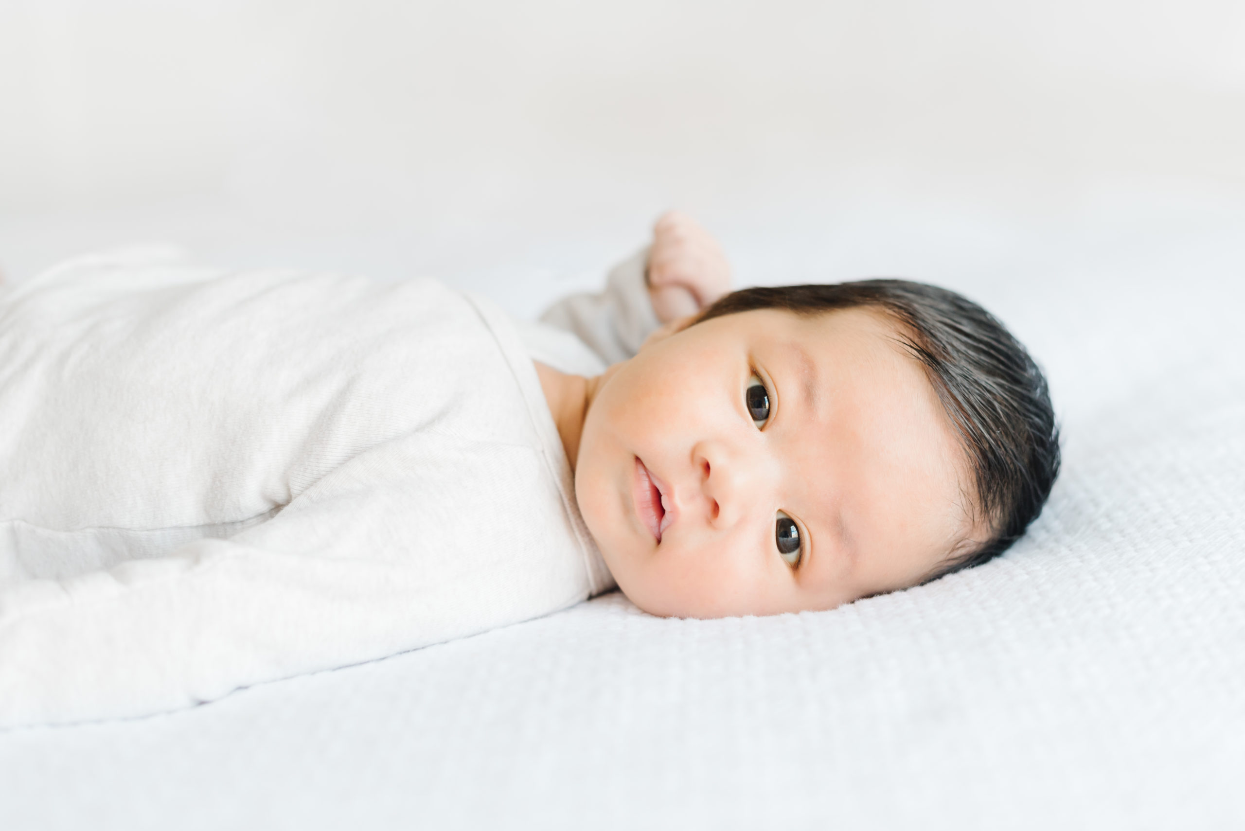 Photo of Baby on Bed at Lifestyle Newborn Session in Washington DC