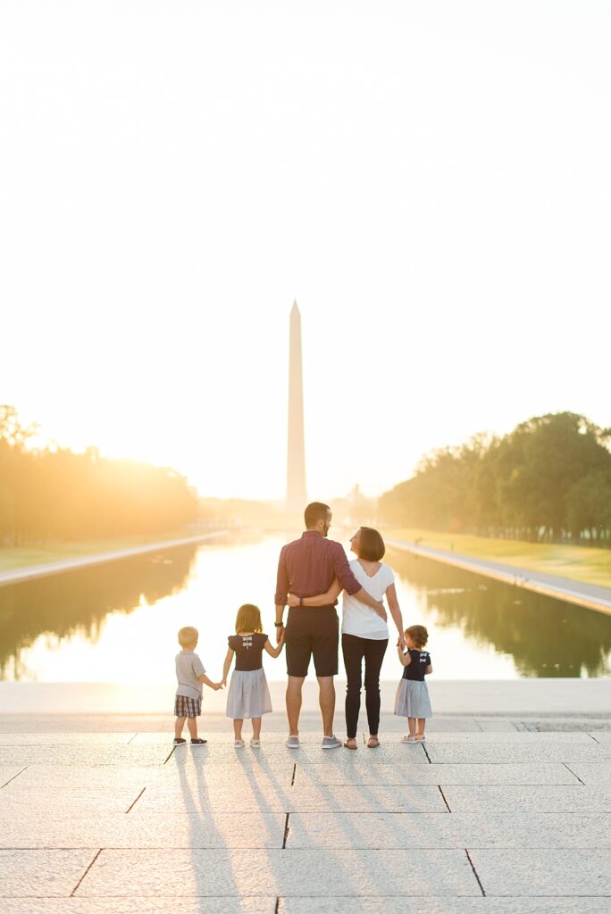Family of five stands in front of the Reflection Pool at the Washington Memorial on the National Mall during their family portrait session with Washington, DC family photographer Mary Catherine Photography